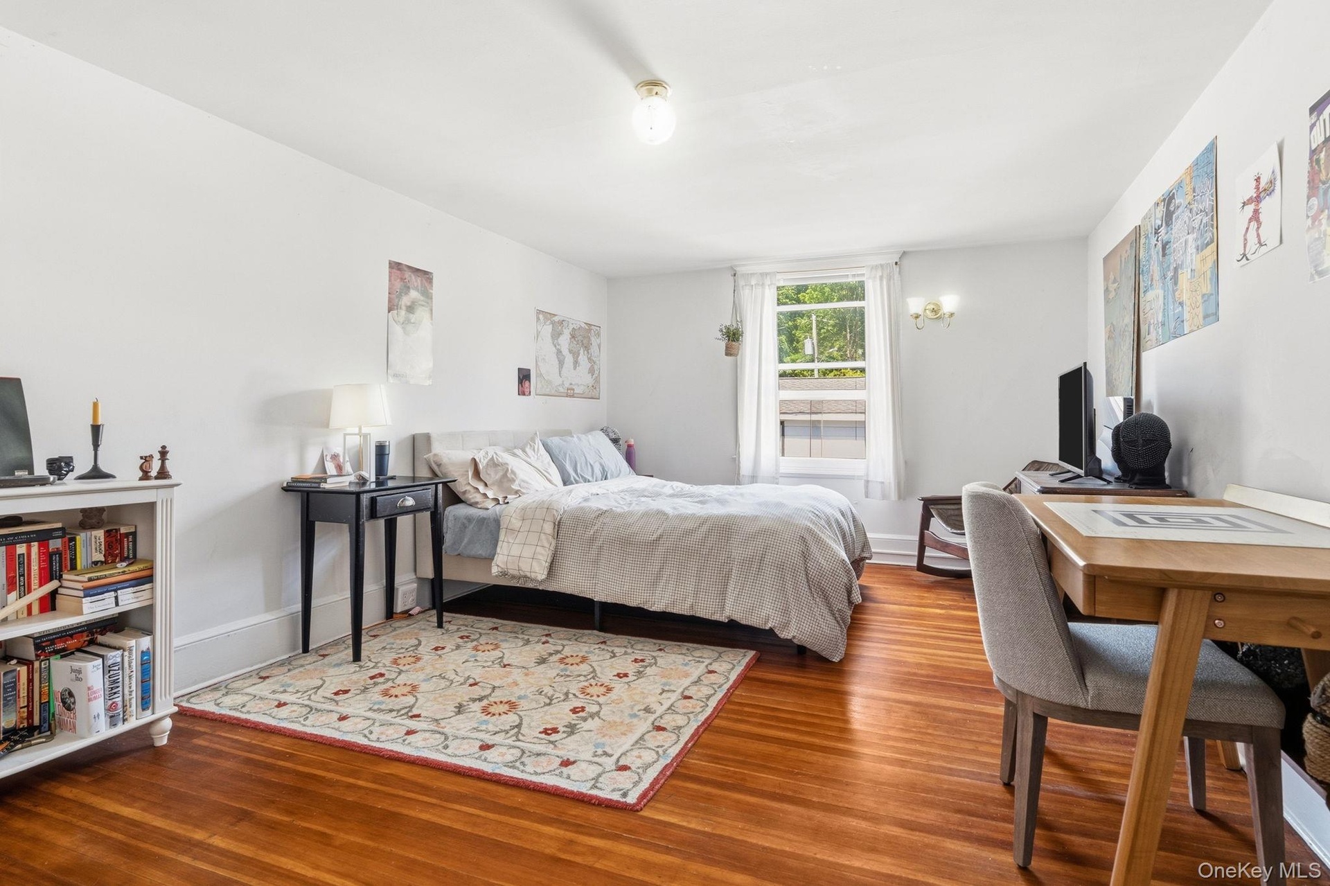 Delightfully bright and cheerful, this upstairs third bedroom is filled with natural light and inviting charm.