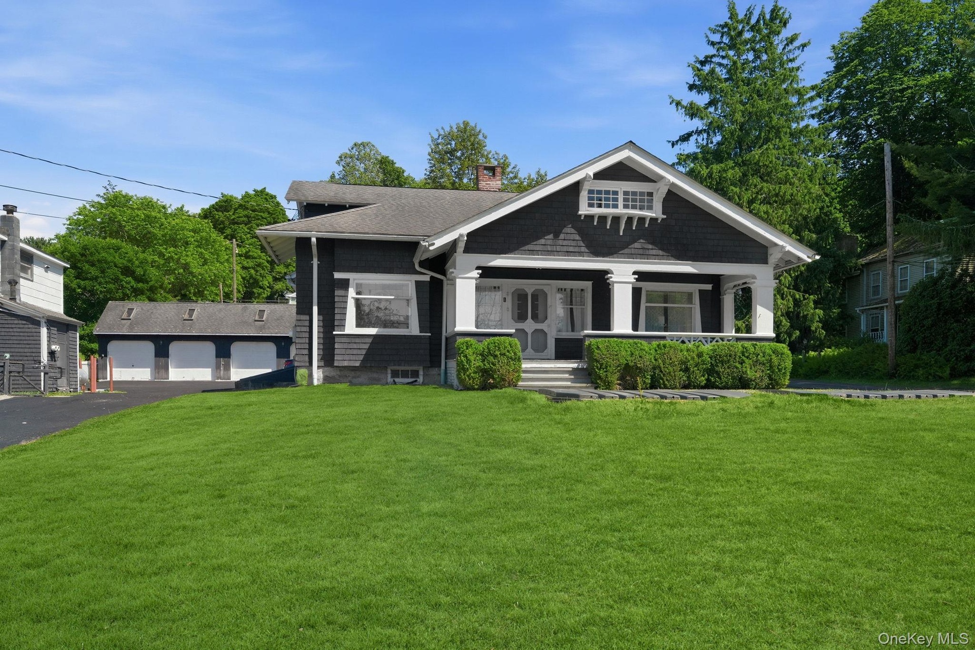 A distinguished Craftsman residence blending historic character with lasting investment value and a view of the 4 car detached garage.