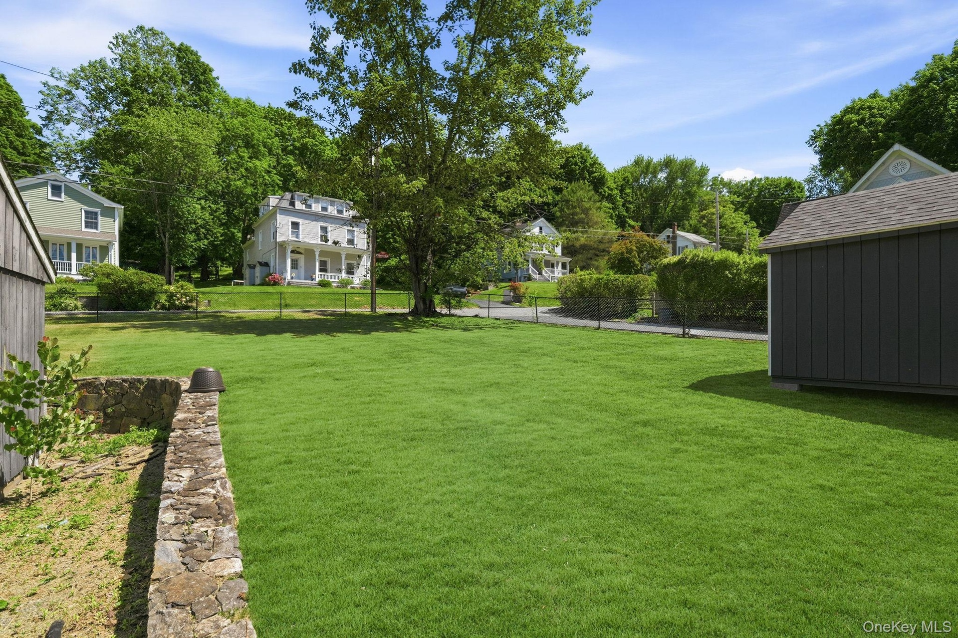 Stretching beyond the garage, the grounds reveal a generous, green landscape with endless possibilities.