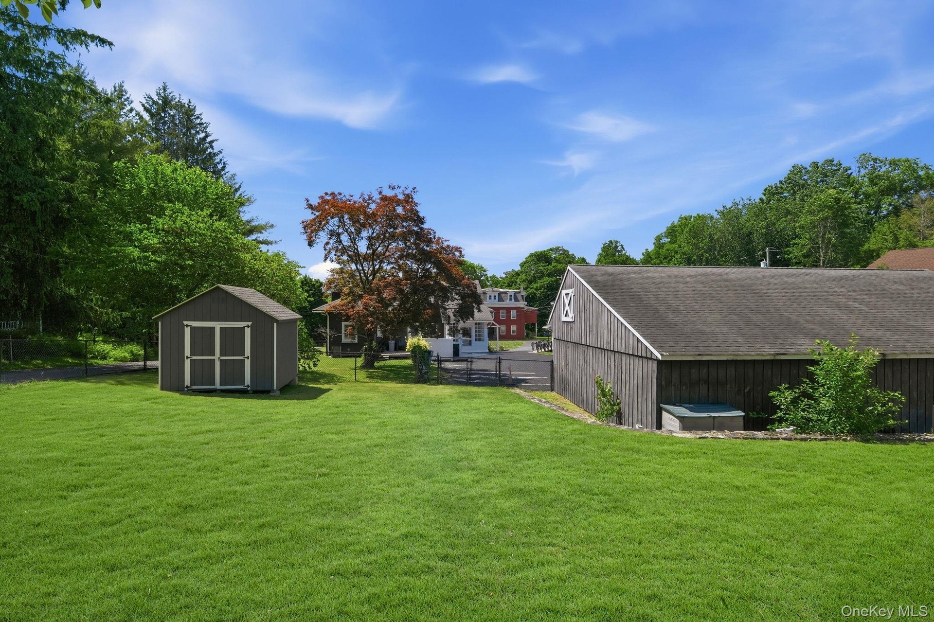 A lush, level expanse of land behind the garage, offering exceptional space, privacy, and future potential.
