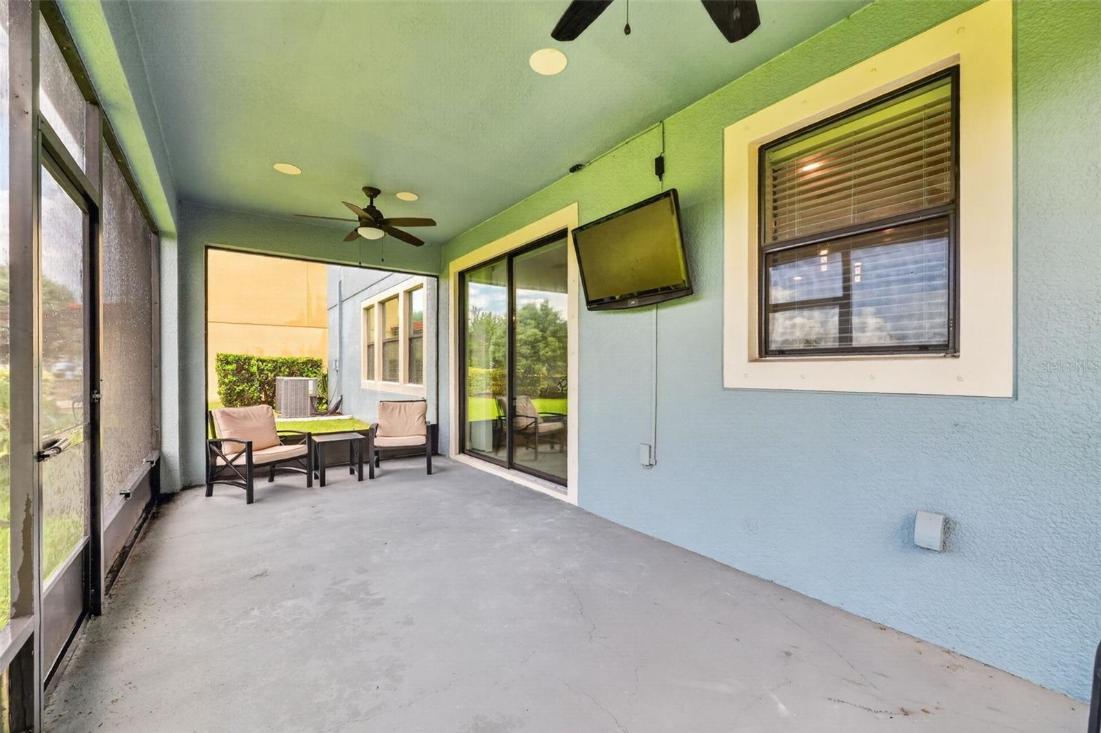 Covered and Screened Lanai with Double Ceiling Fans, Pre-Wired for Speakers and T.V. Large Screen Panels for Gorgeous View of Peaceful Natural Landsca