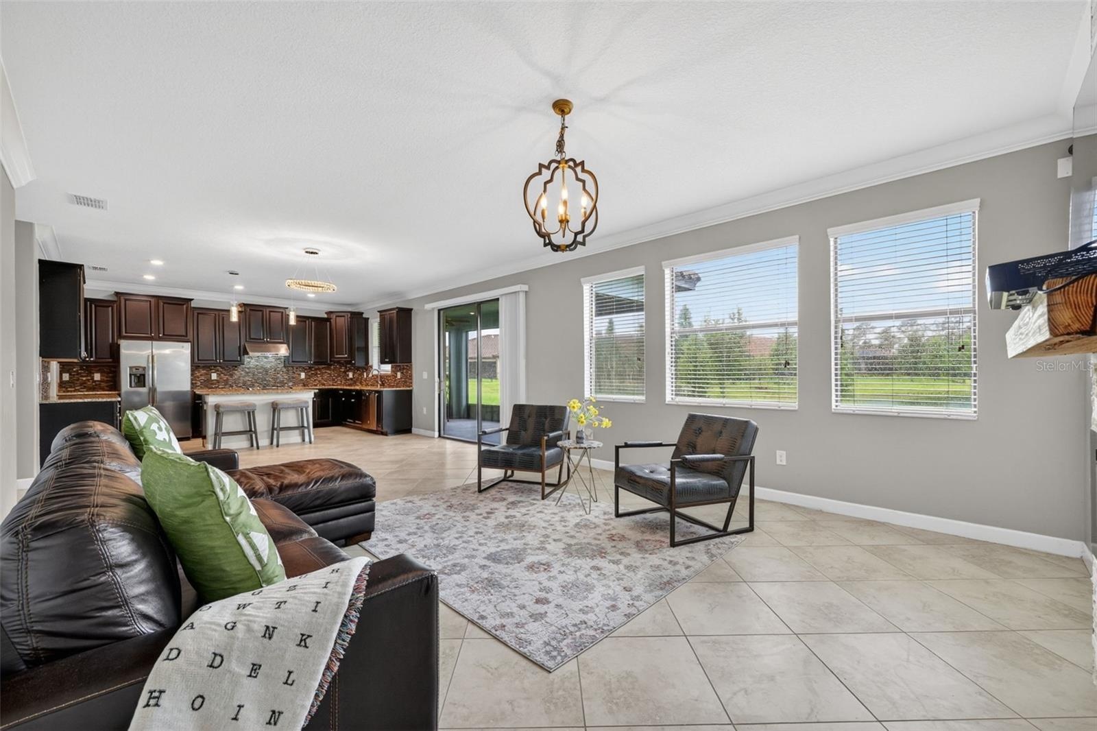 View from Windows to Tranquil Pond and Landscaping. Tons of Natural Light with Windows, Double Glass Sliding Doors, and Window from Kitchen Sink overl