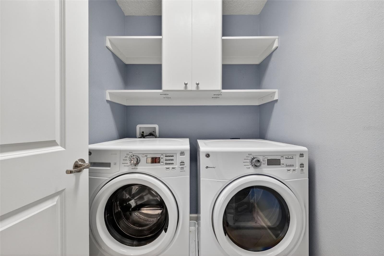 Upstairs Inside Laundry Room with Custom Cabinet, Shelving, and GE Washer & Dryer