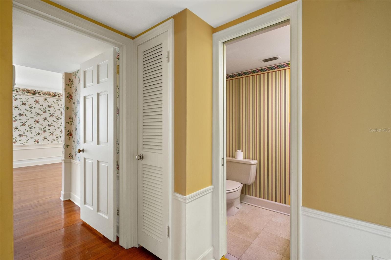 Hallway between bedrooms with powder bath