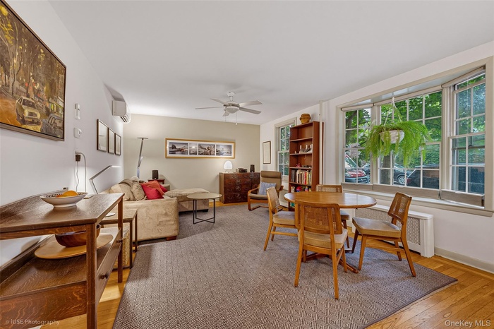 Bright living space featuring hardwood flooring and a bay window