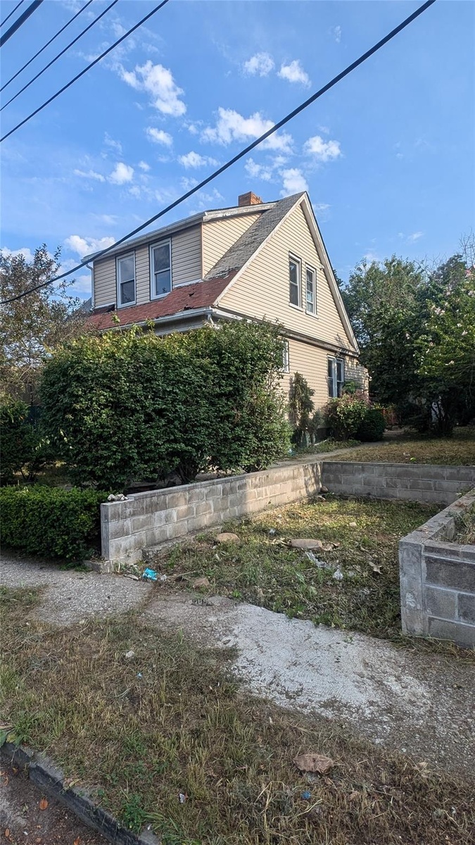 View of side of home featuring a chimney