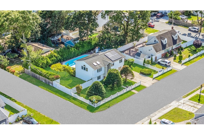 Aerial view of residential area featuring a pool