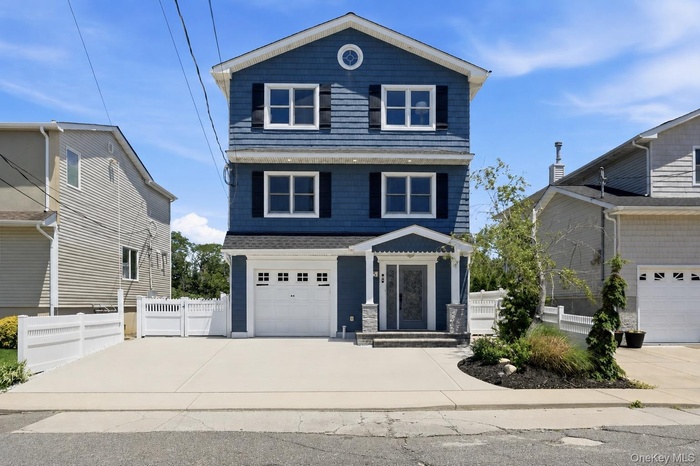 Three-story residence featuring blue siding with white trim and black shutters