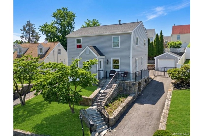 Two-story residence featuring light gray siding and a dark gray roof