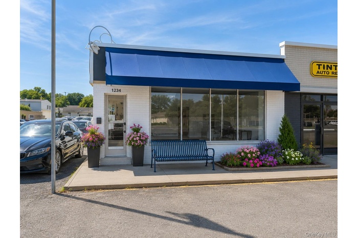 Shown with AI-enhanced exterior improvements, including landscaping and awning, to illustrate potential curb appeal.