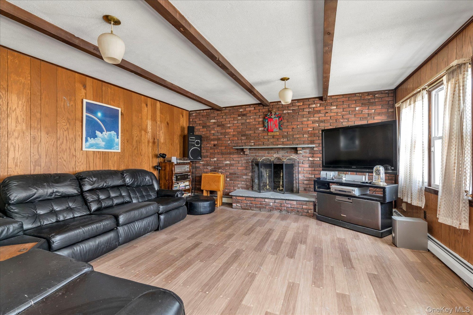 Family room with wood burning fireplace. Great option for formal dining room.