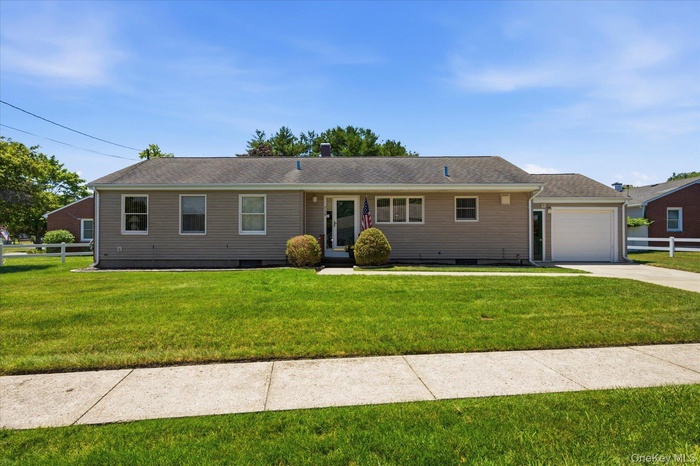 Front of home with Cement Driveway and Sidewalk lined street