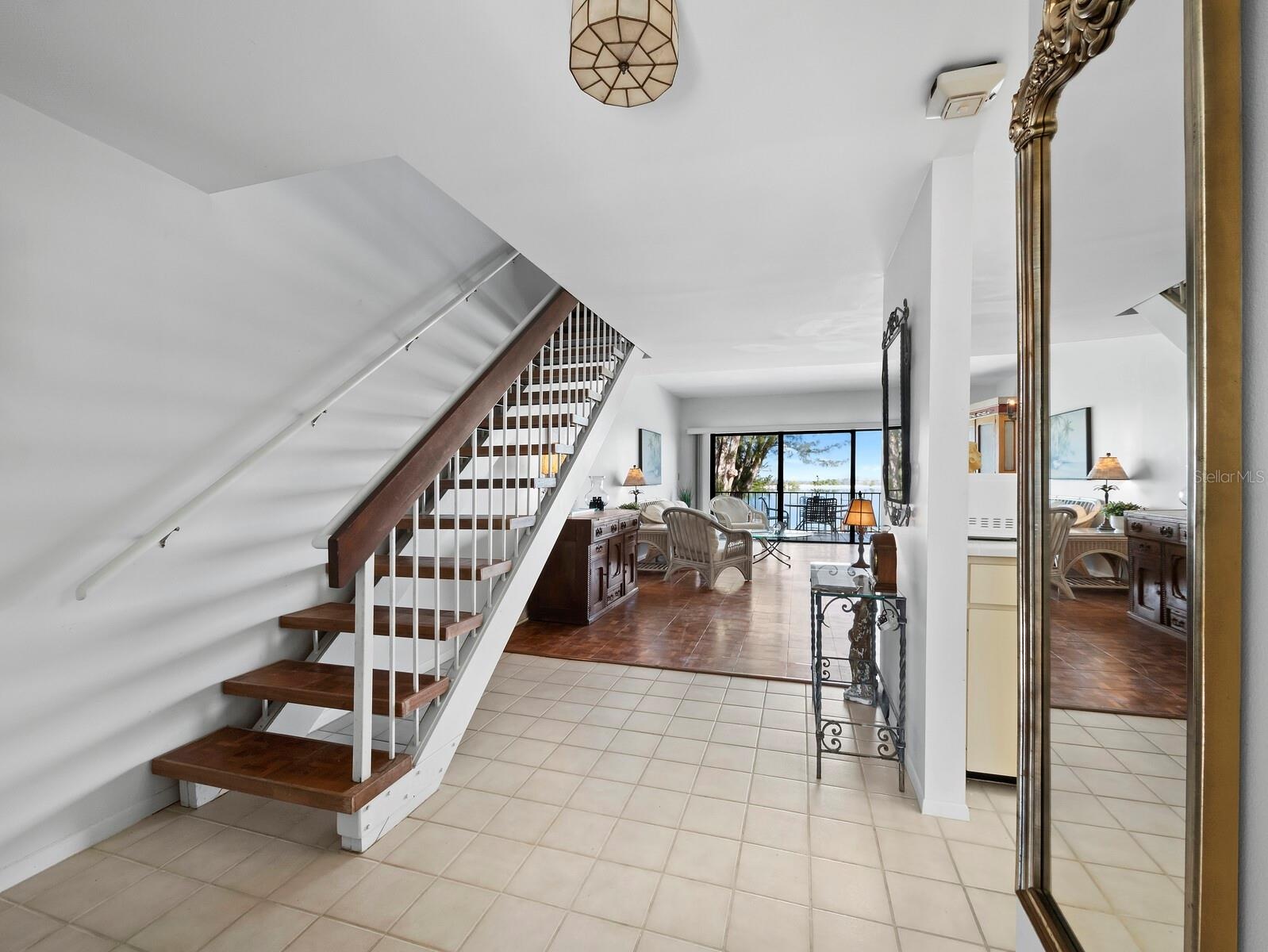 Take the steps from the first living level up to your primary ensuite bedroom, 2nd bedroom and 2nd bath