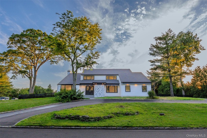 Modern exterior with white siding and dark trim