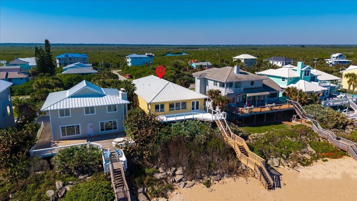 Aerial view of home showing steps to beach