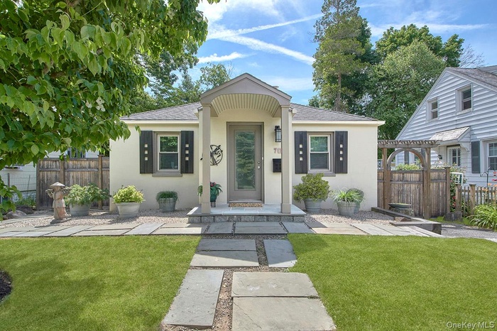 Front of house with gate and Pagoda to fenced in back yard