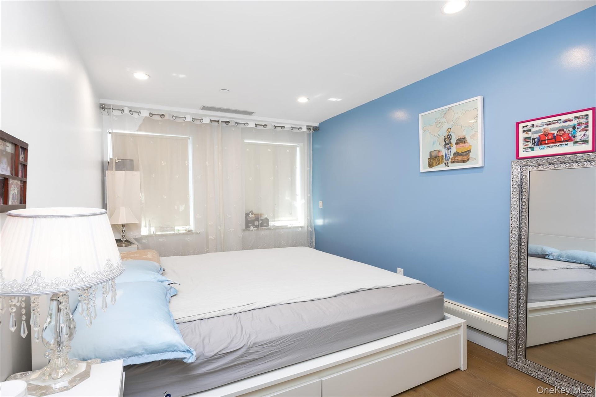 Bedroom featuring wood finished floors, recessed lighting, and baseboard heating