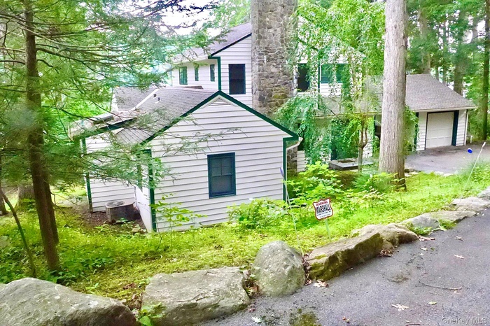 The home has two private bedrooms downstairs, and two up, with an open-plan kitchen, dining, and living area with views of the lake.