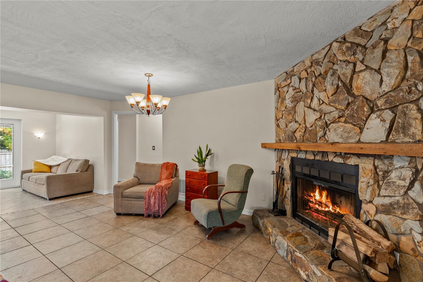Cozy fireplace gathering area centered around a charming wood-burning fireplace, creating a warm and inviting space to relax, unwind, and enjoy time w