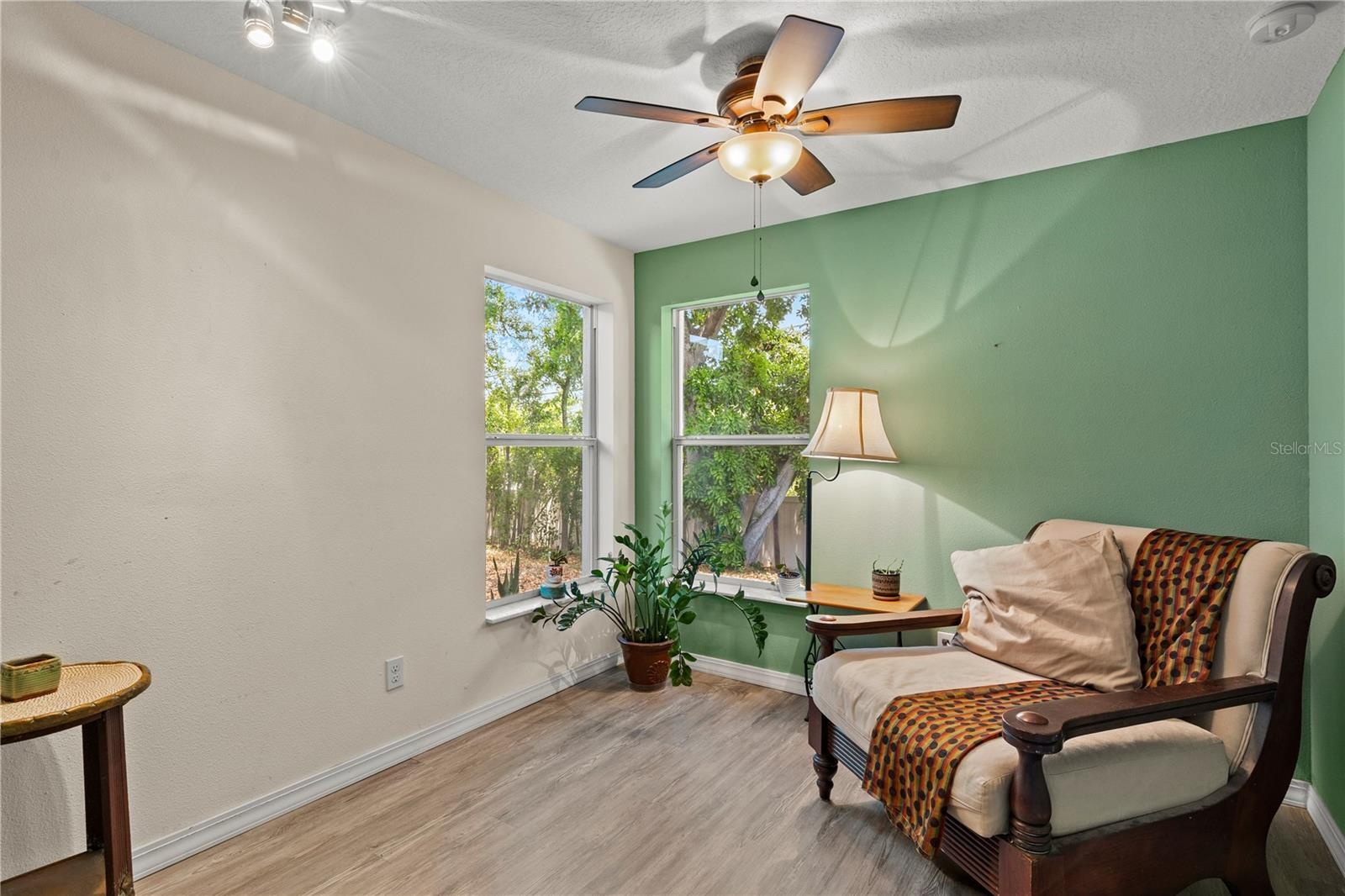 Spacious primary bedroom retreat featuring a bright and airy layout with a comfortable sitting area, creating the perfect space for relaxation and pri