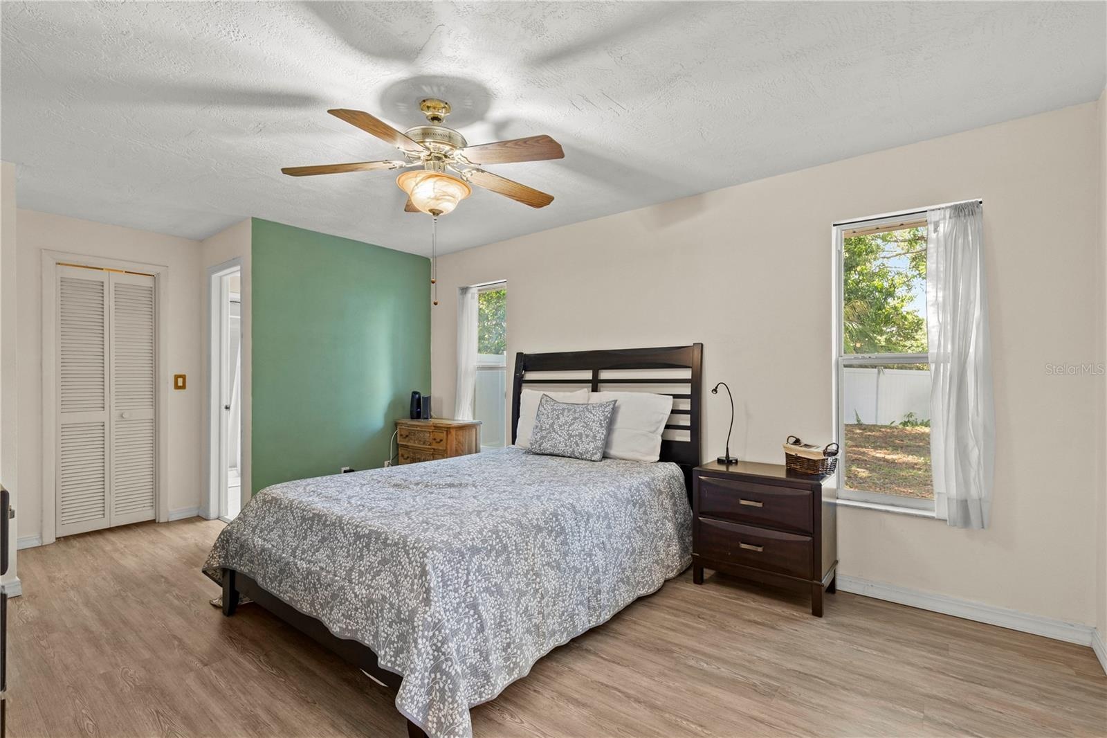 Spacious primary bedroom retreat featuring a bright and airy layout, offering a comfortable and private space to unwind. The room provides ample natur
