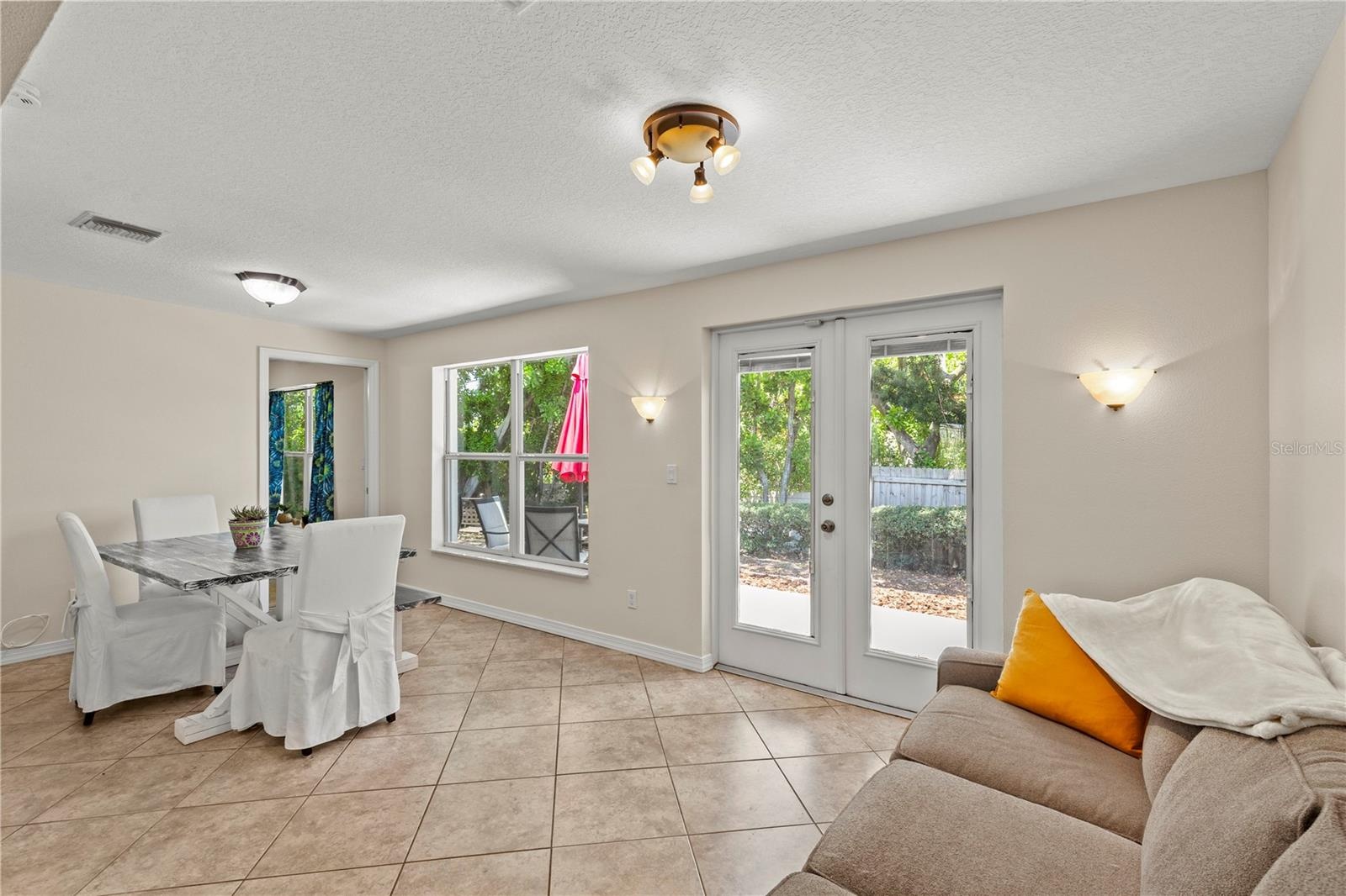 Versatile Florida room filled with natural light, offering the perfect space for a dining area, sitting room, home office, or additional living space.