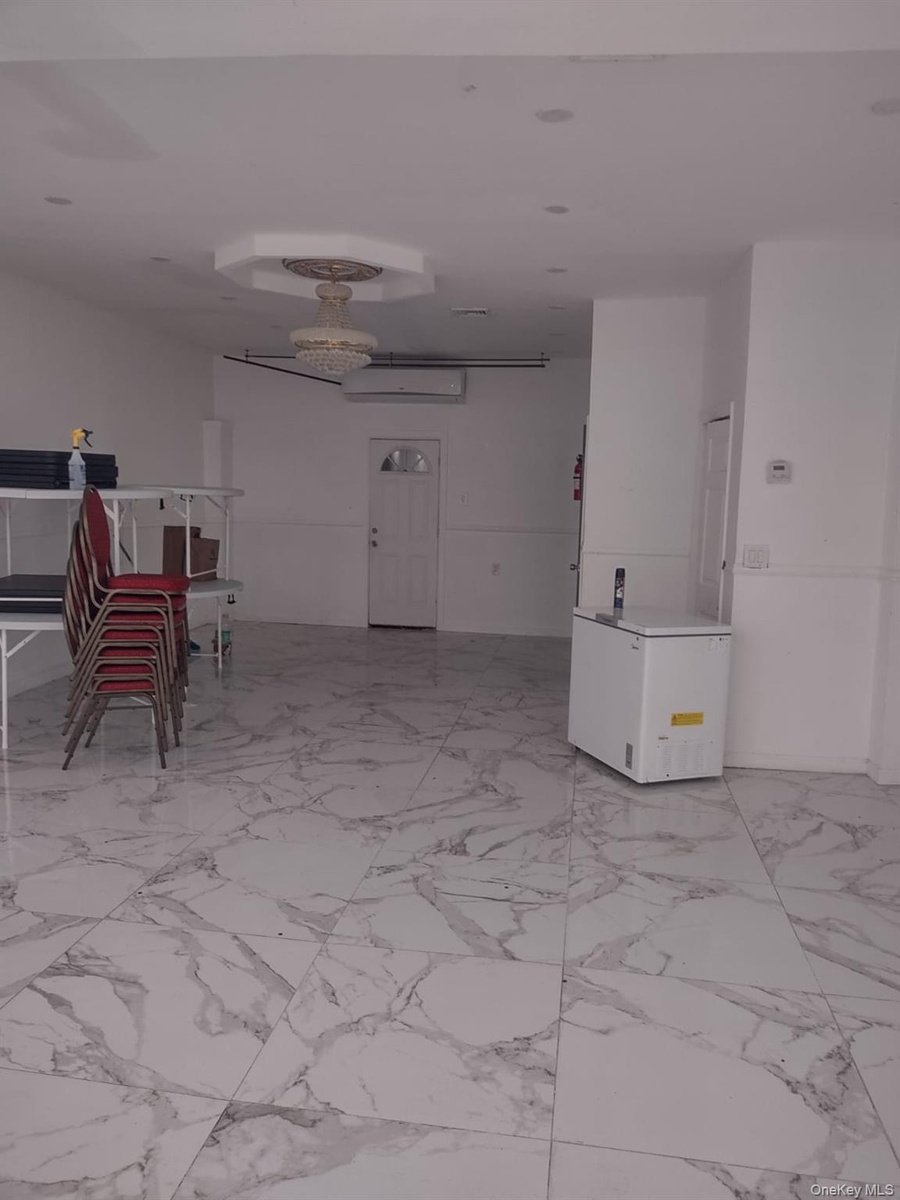 Spare room featuring light marble finish flooring