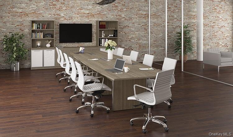 Office area featuring brick wall, wood finished floors, and built in features