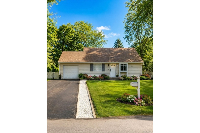 Single-story residence featuring light-colored siding and a brown shingle roof  photos have been digitally enhanced to illustrate the property's poten