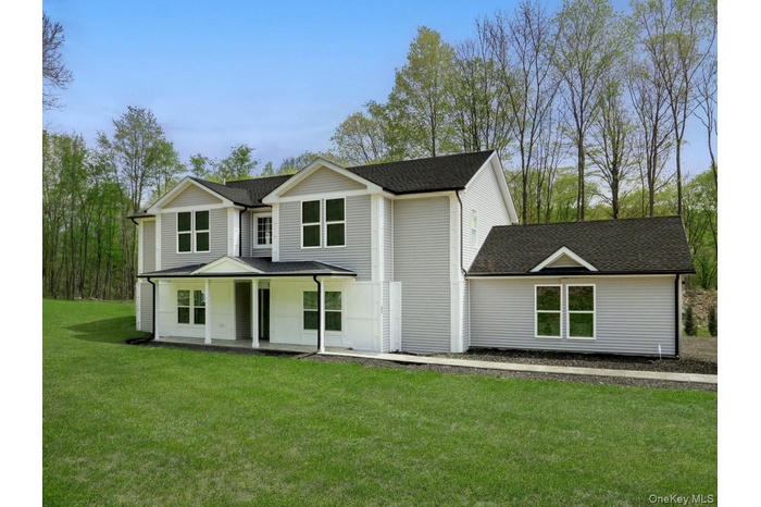 Contemporary two-story residence featuring light gray siding and a dark shingle roof