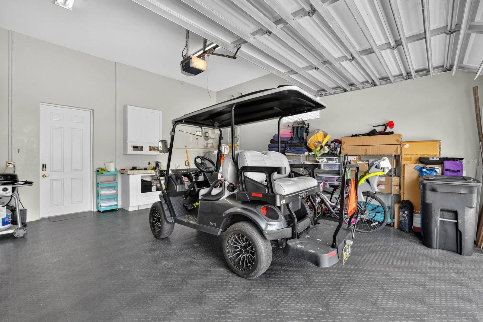 Two car garage with golf cart included.  Cabinets, mud sink, refrigerator