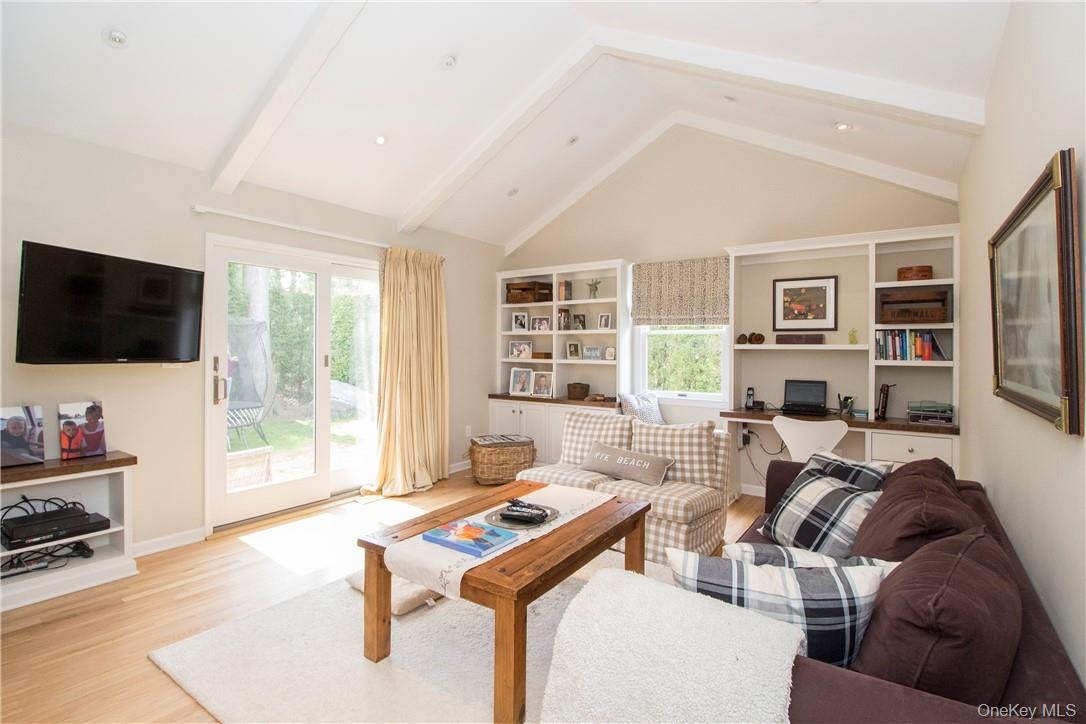 Family room with fireplace, doors to backyard and built-ins