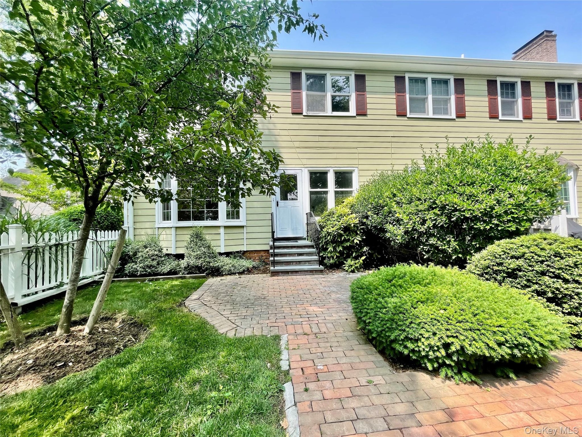 Private backyard with brick patio. Landscaping and snow removal included.