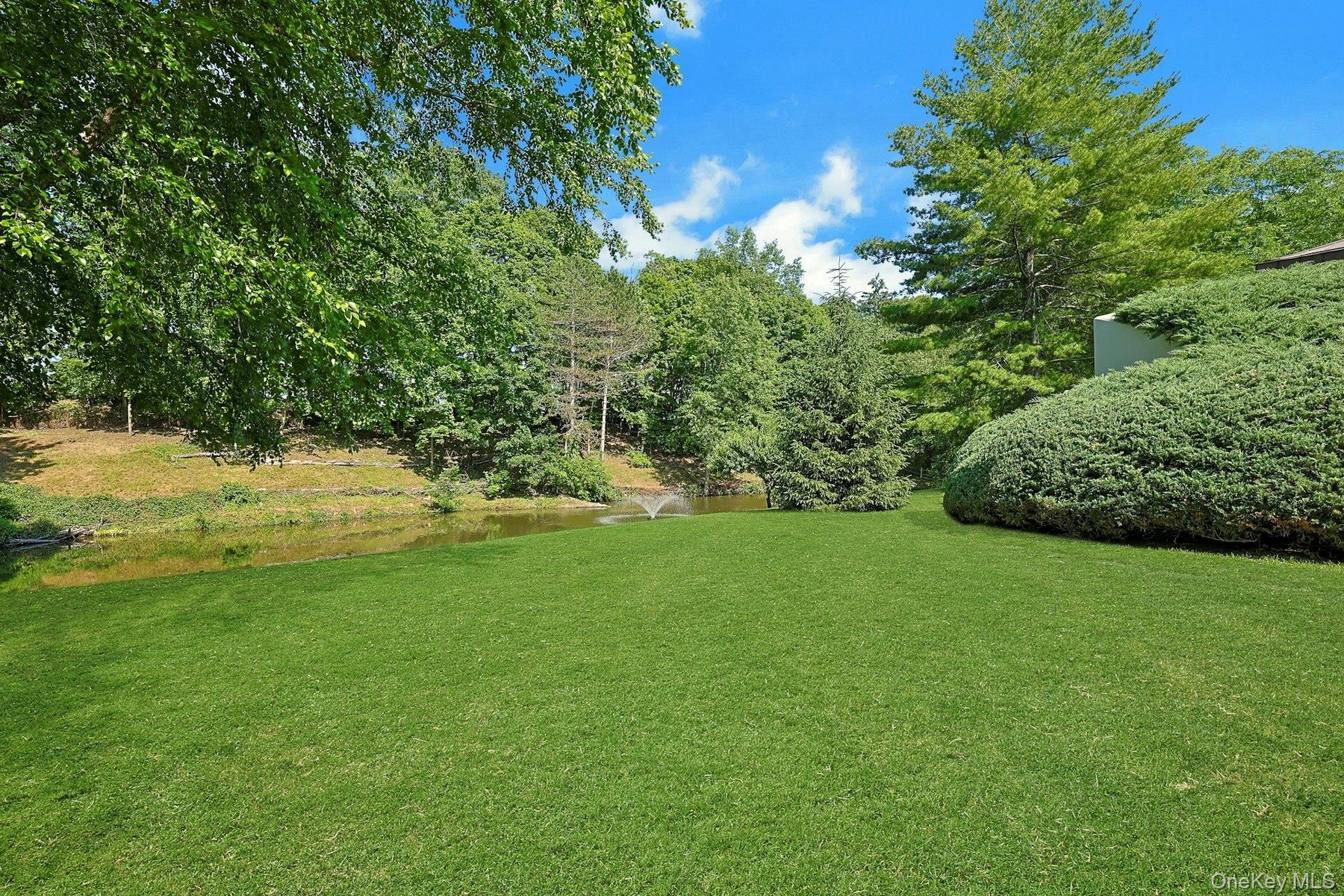 A broad, level lawn offers the ideal setting for recreation, sports, and outdoor enjoyment while overlooking the picturesque grounds.
