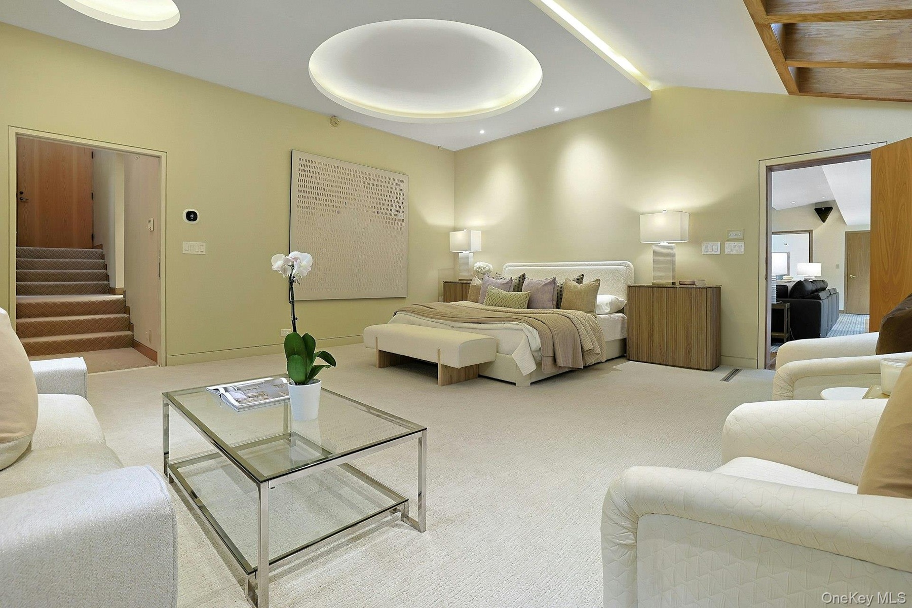 The expansive primary suite offers exceptional scale with room for multiple seating areas and a true sanctuary-like atmosphere.