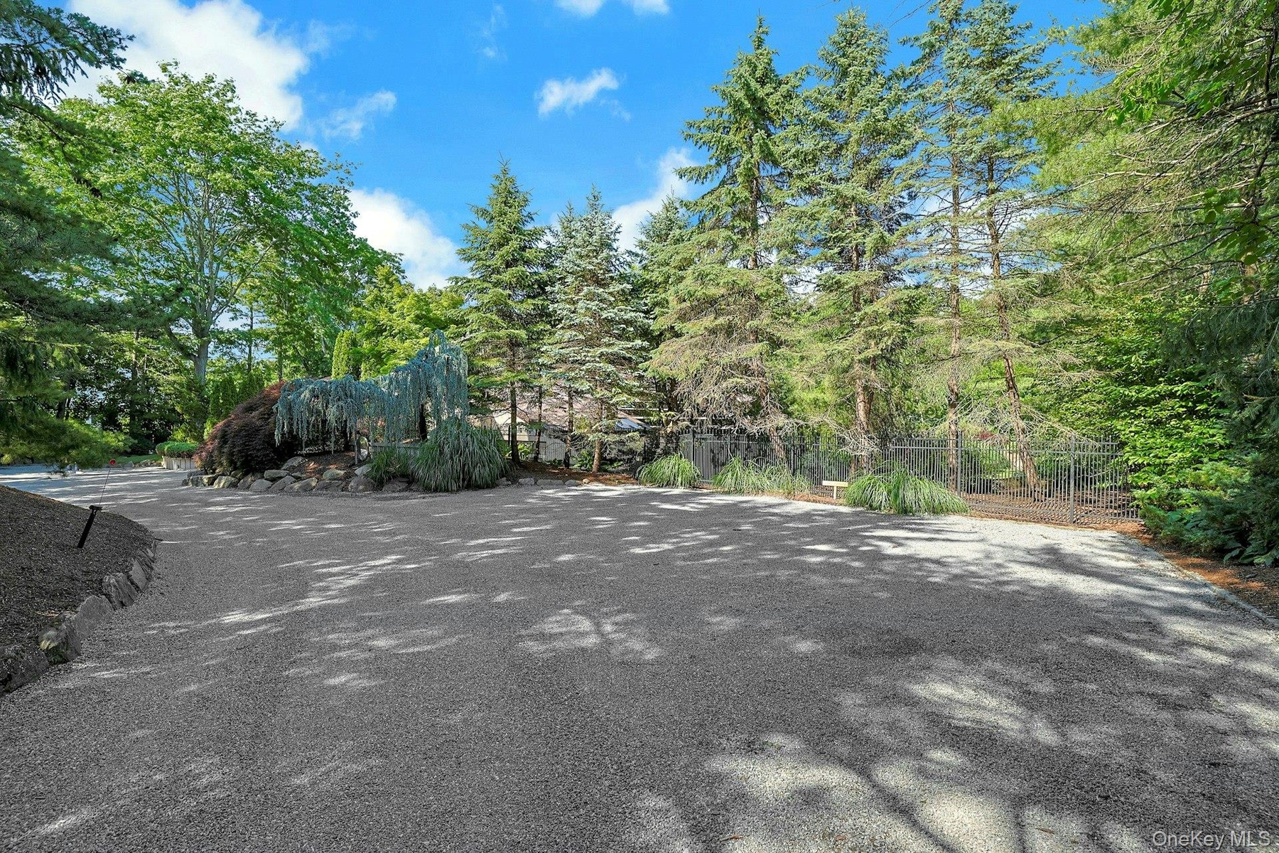 A spacious front guest parking court welcomes visitors with ease and accommodates gatherings large and small.