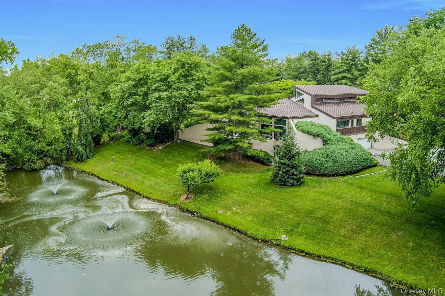 Sweeping views reveal the stunning relationship between the residence, the pond, and the surrounding landscape.