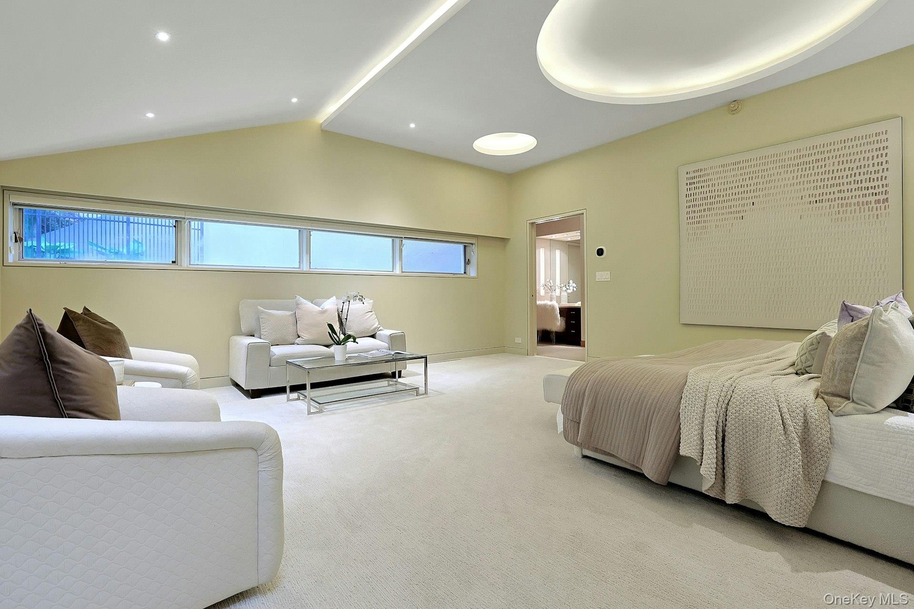 Designed as a private retreat, the primary bedroom combines generous proportions with a tranquil, light-filled setting.