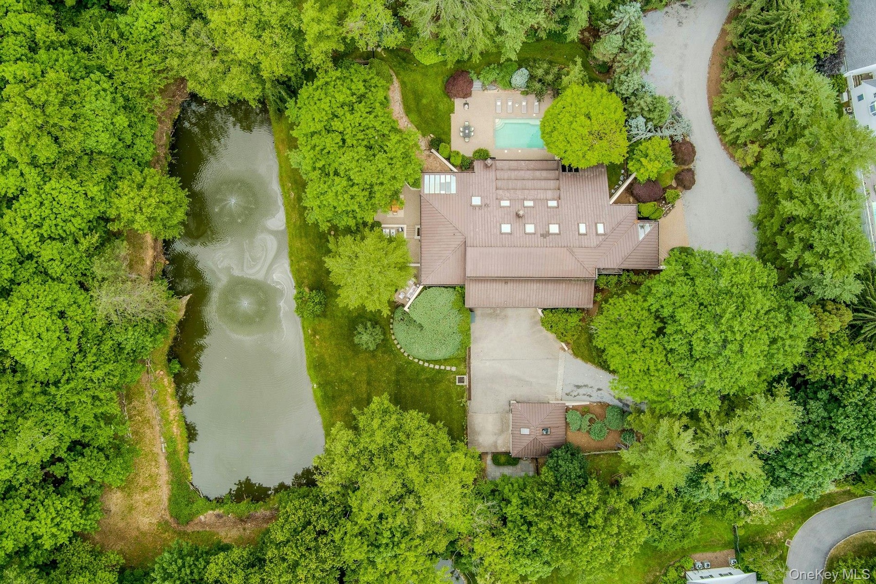 From above, the home's unique design is beautifully integrated into its lush natural surroundings.