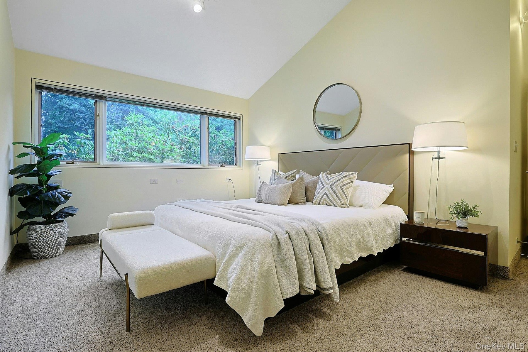 One of three generously sized bedrooms in the kids' wing, offering peaceful treetop views and ample closet space.