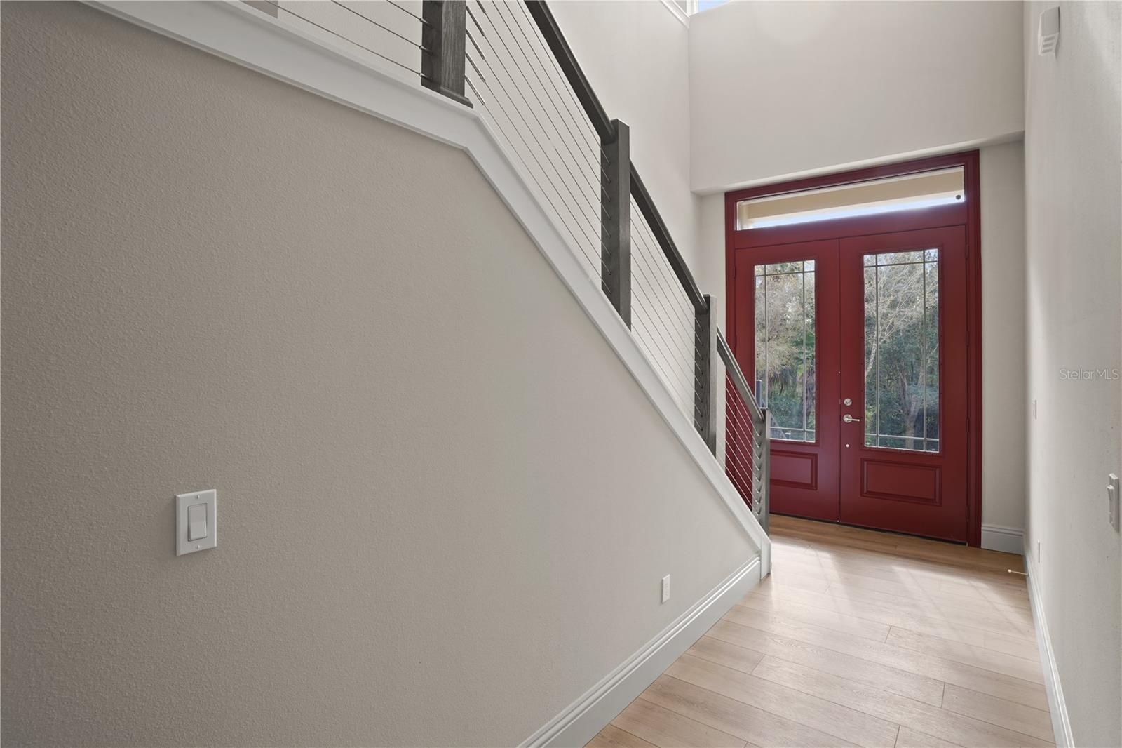 Grand foyer makes an immediate impression wit its soaring two-story ceilings and abundant natural light.  Impressive double front doors with decoratio