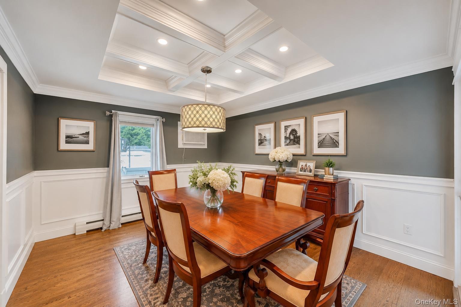 Coffered ceiling with recessed lighting and a decorative chandelier
