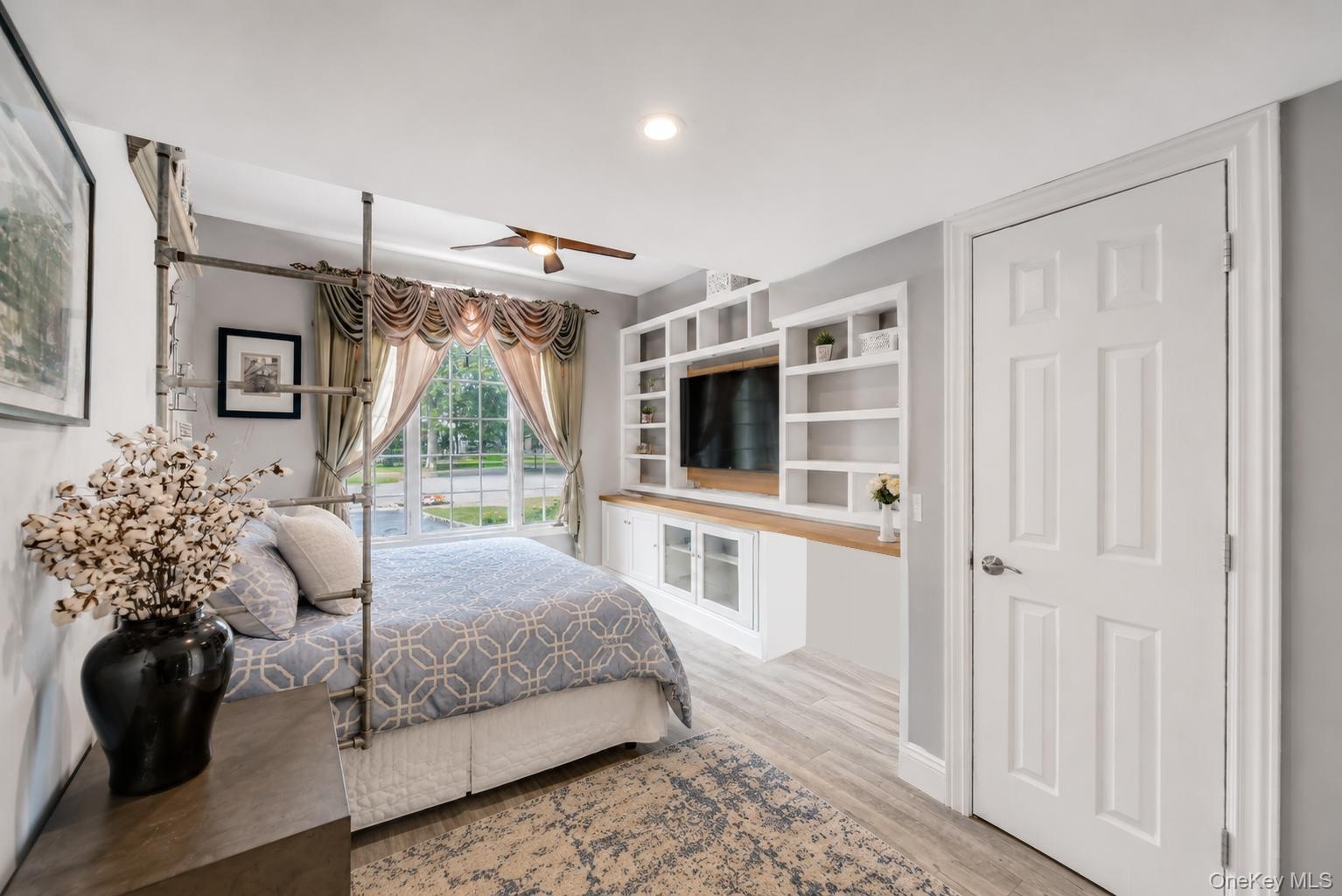 Built-in entertainment center with open shelving and wood-finish countertop