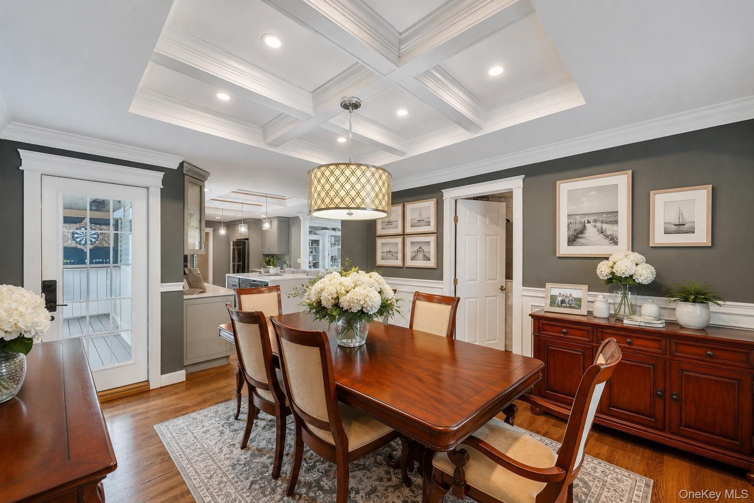 Dining area featuring a coffered ceiling, recessed lighting, and wood-finish flooring