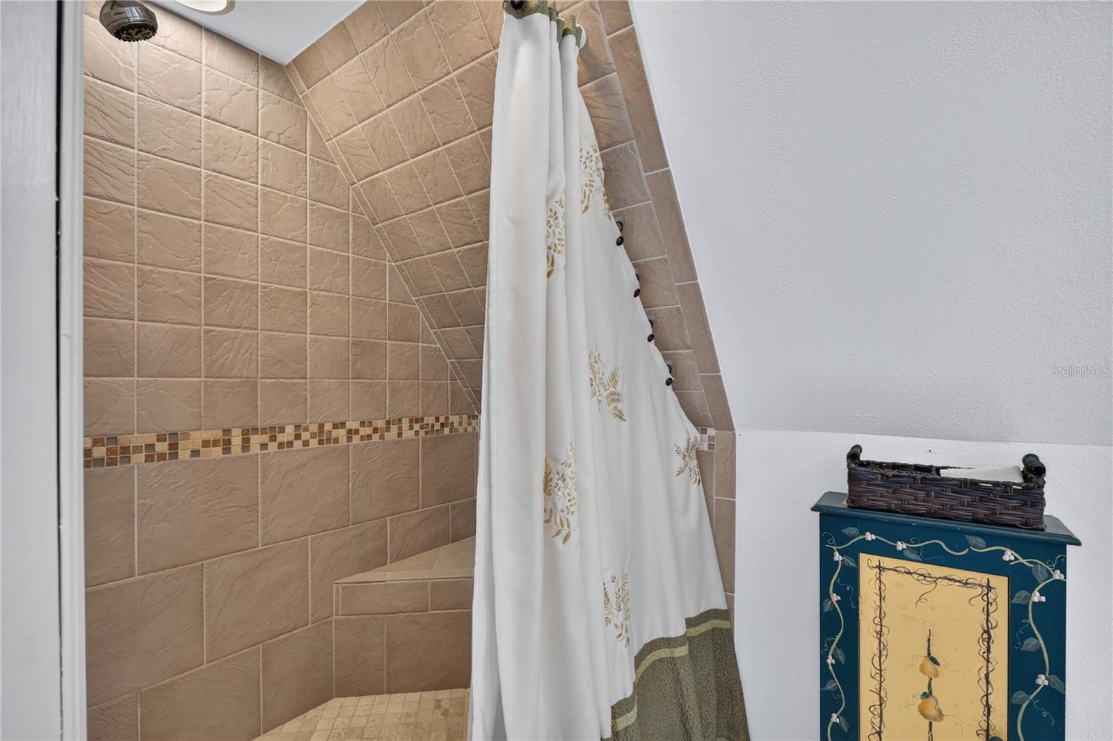 Tiled primary shower with seat