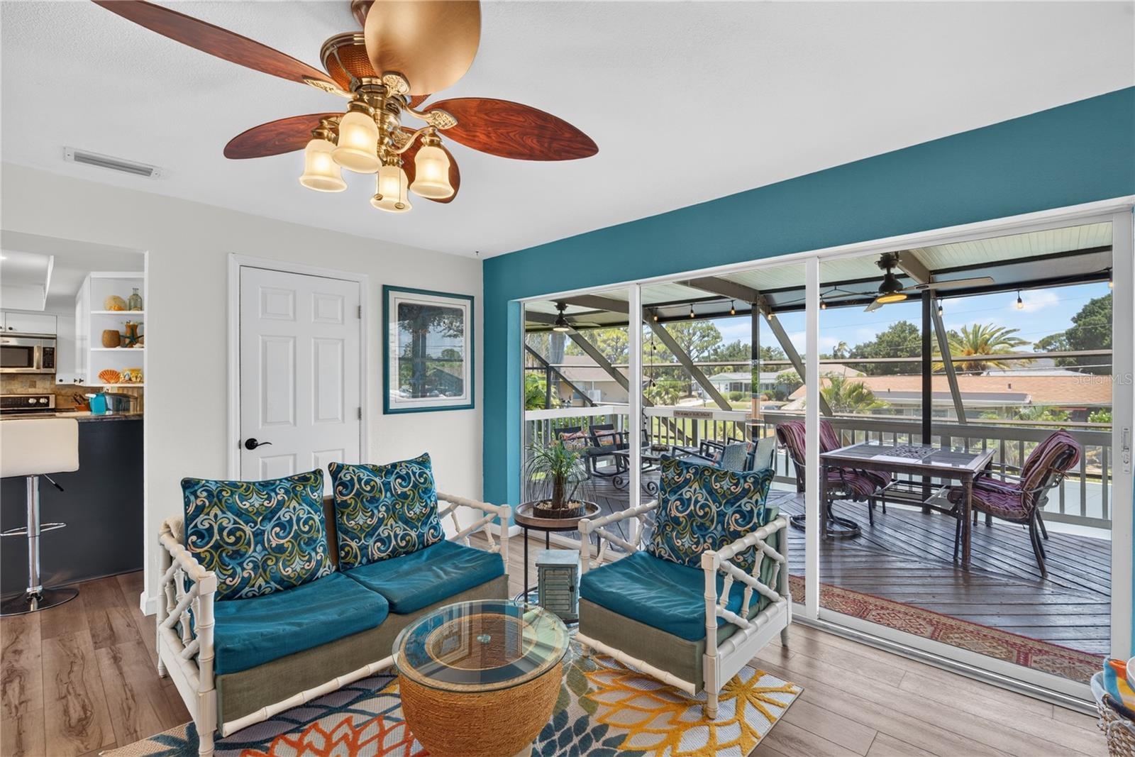 Family room with sliding glass doors opening to large outdoor deck