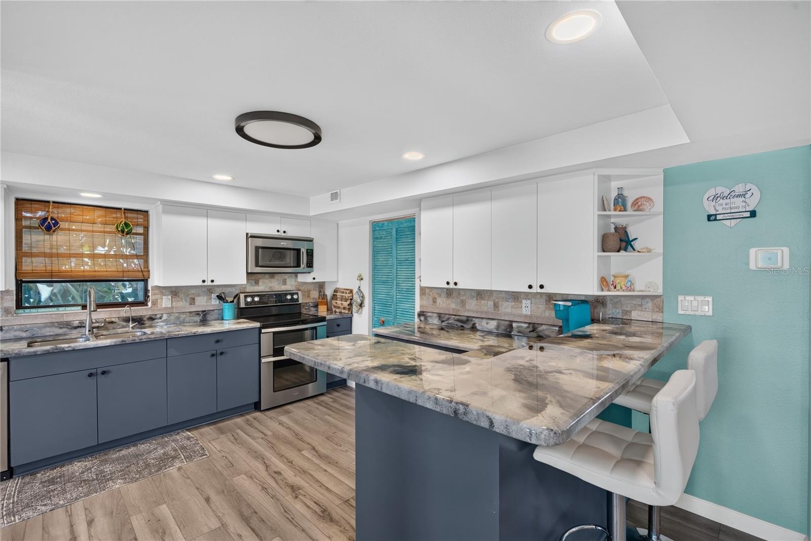 Expansive kitchen with barstool space and open layout.