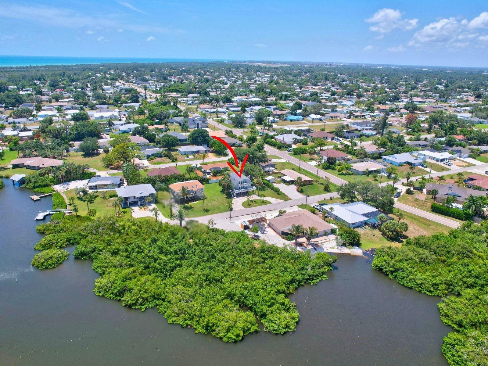Aerial perspective of the surrounding neighborhood and nearby water features.