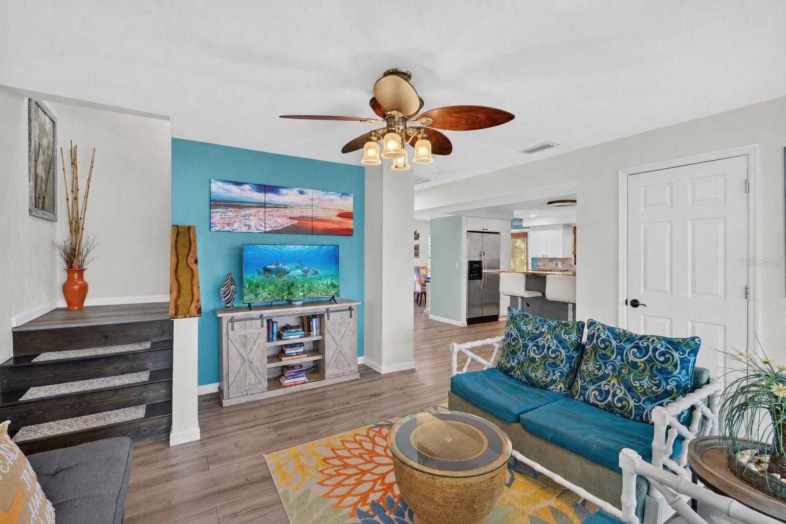Open living area with coastal-inspired furnishings and bright interiors.