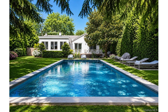 Salt Water Pool, wood deck for outdoor dining & entertaining, luscious landscape.